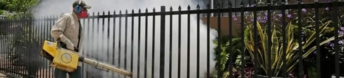 Mosquito control technician fogging a yard perimeter for mosquito reduction in Pittsburgh, PA